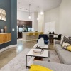 Spacious and well lit living room with concrete floors 