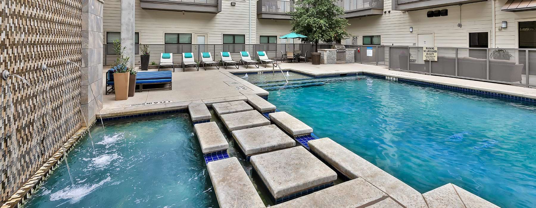 Sparkling swimming pool with large pool deck and cabanas